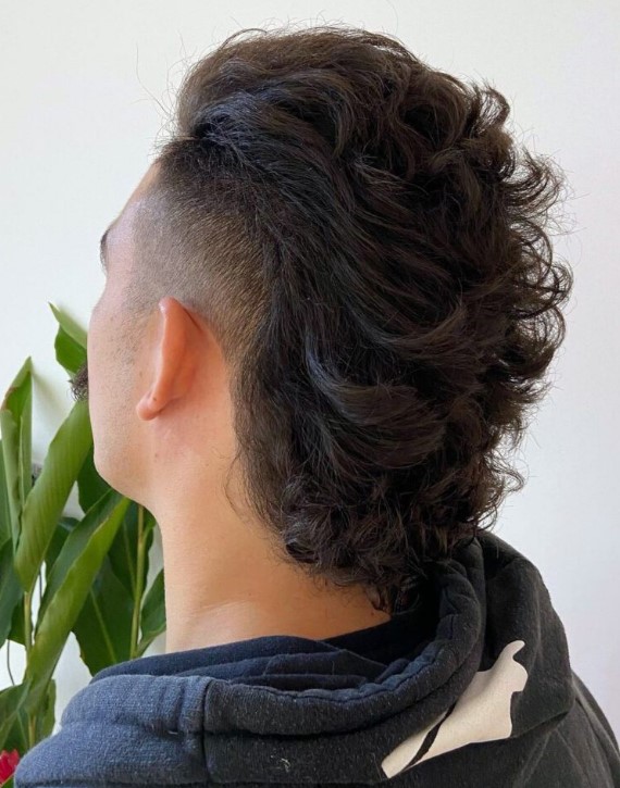 a pushed back long mullet with an undercut is a very statement-like hairstyle and natural curls make it look wow