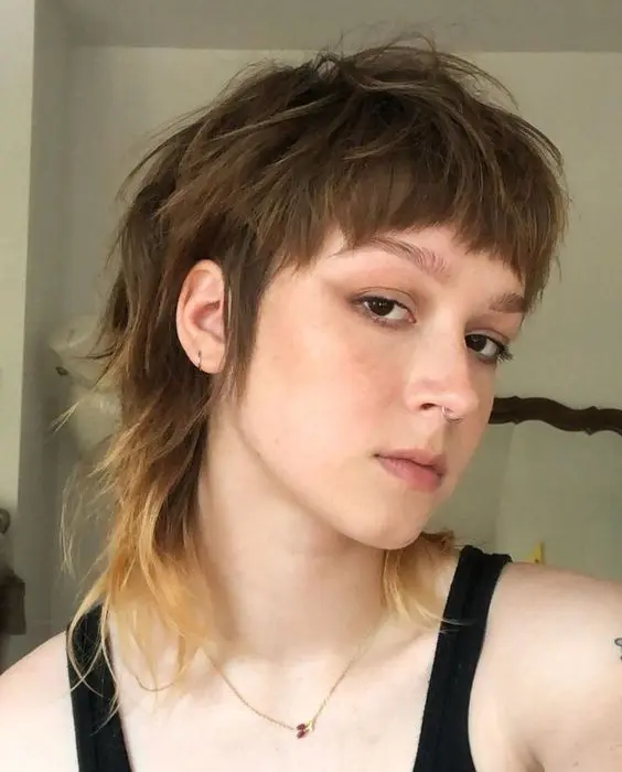 a short brunette mullet with long sides, bangs and an ombre blonde touch at the ends is amazing