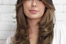 a splendid butterfly haircut in brown, with caramel balayage and curtain bangs is a gorgeous idea