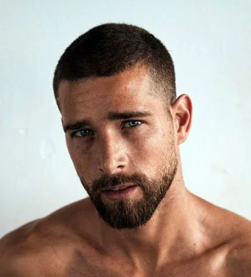 a stylish and classic buzz cut on thick hair paired with a beard is a chic and edgy idea