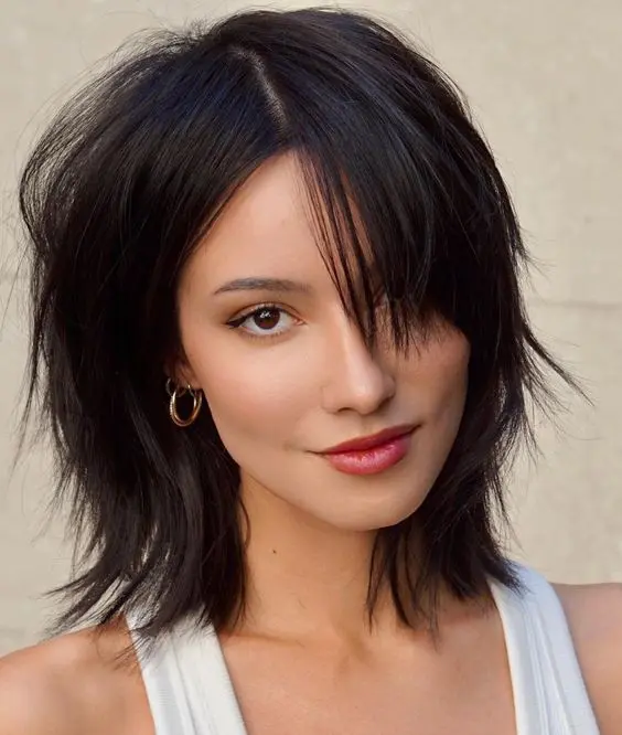 a stylish black medium wolf cut with messy texture on straight hair is a bold solution with a bit of edge
