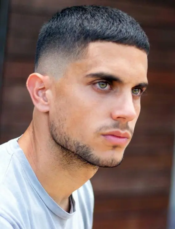 a tough and classy shiny buzz cut with a sharp line up and a clean subtle taper fade, the top is slightly above buzz