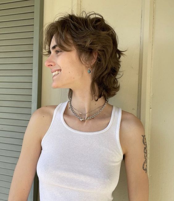 a wavy brown short mullet with curtain bangs and a bit of dimension is a catchy and effortless solution