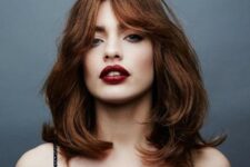 beautiful auburn medium length hair with waves and bottleneck bangs is a pretty and lovely solution
