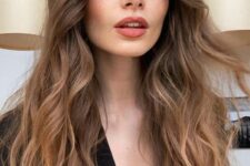 beautiful long brunette hair with a slight ombre effect, bottleneck bangs and waves is a super chic and refined idea