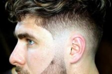 brushed forward wavy hair with low taper and a beard is a new way to add volume to your hair, and such a beard sharpens your jaw