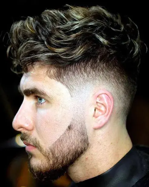 brushed forward wavy hair with low taper and a beard is a new way to add volume to your hair, and such a beard sharpens your jaw