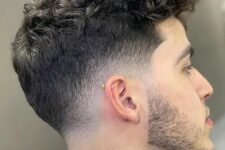 curls with a low drop fade are a classy way to let your texture shine and a beard adds interest here