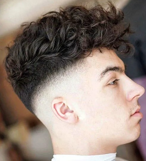 curly hair with long frigne and a high drop fade is a cool idea, style it for an interesting and sexy look