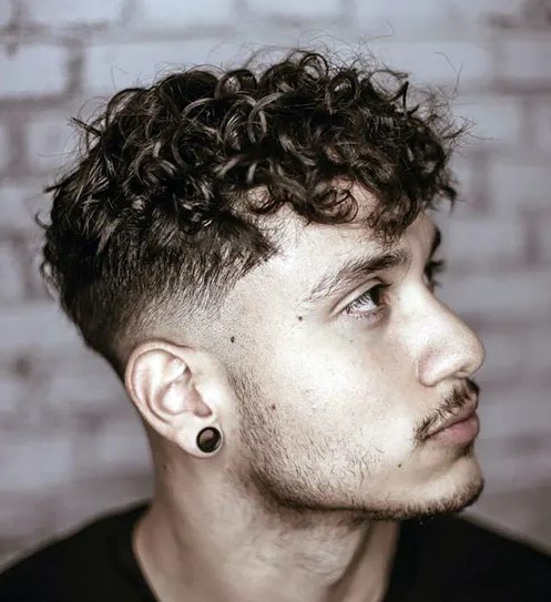 messy curly hair with a tape fade is a creative take on classics, and you can style it with a blow dryer