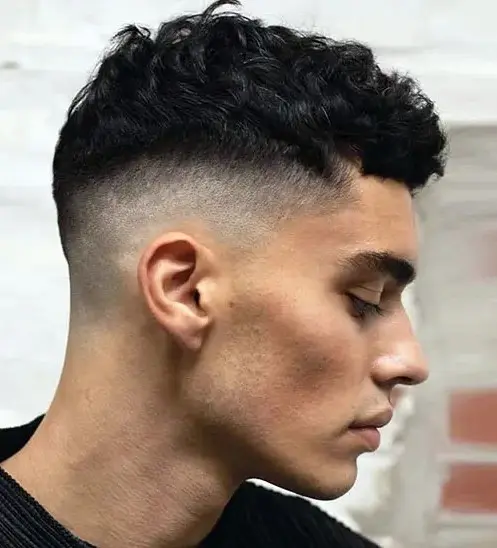 short curls with a high fade look clean and edgy, style them with pomade for an irresistible look