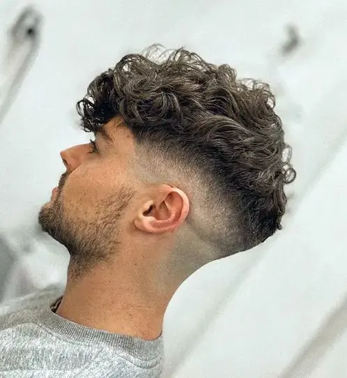 thick curly hair with a mid bald fade with a clean-cut finish, use pomade for some extra volume