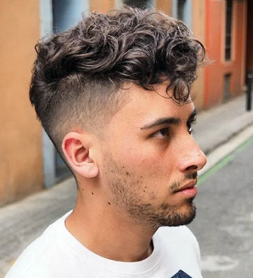 tousled curls with a high undercut fade look effortlessly chic and cool and will show off the texture of your hair