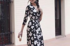 02 a black floral maxi dress with long sleeves and a V-neckline, black tassel earrrings, metallic shoes and a clutch