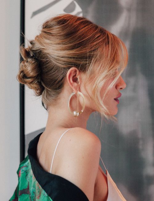 a braided updo with a bump on top and locks framing the face is a catchy and sexy idea for a bridesmaid