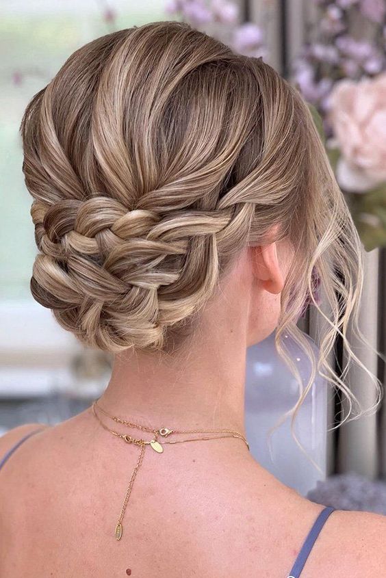 a braided updo with a volume on top and waves down is a lovely boho or just romantic bridesmaid hairstyle