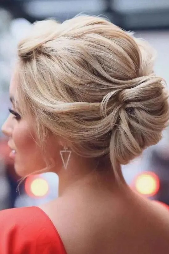 a beautiful twisted low chignon with a twisted volume on top and a bit of locks down is a chic and cool idea