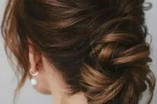 07 a chic low ballerina bun with a bump on top and face-framing locks is a cool idea for a wedding