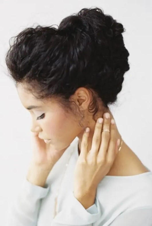 a chignon hairstyle with straightened curls looks natural, casual and catchy