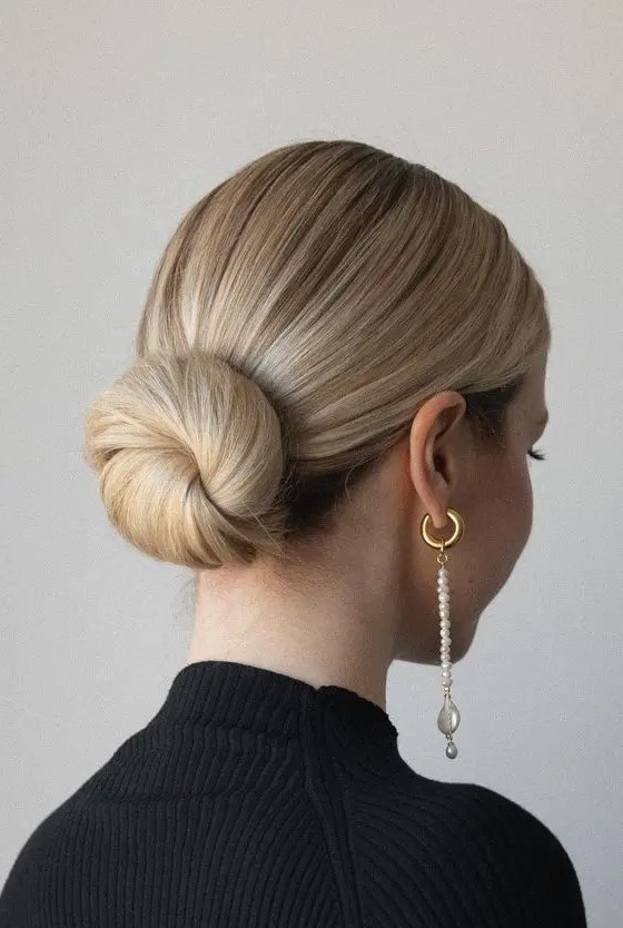 a classic ballerina low bun with a sleek top is a perfect solution that works with most of formal outfits at the wedding