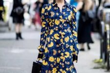 09 a bold fall wedding guest dress, a navy with yellow floral prints, black boots and a black bucket bag makes a statement with its contrast