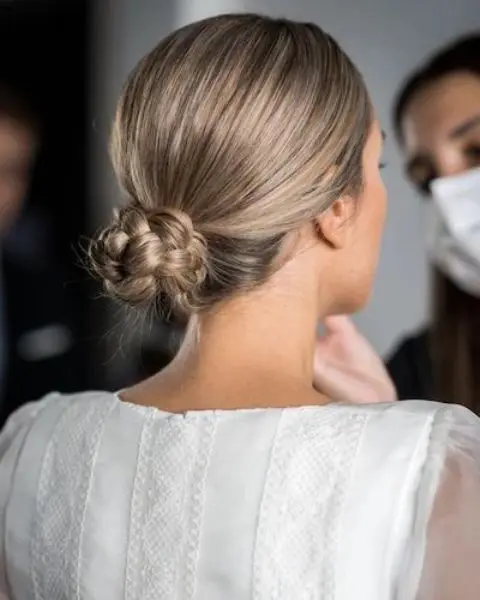 a braided low bun with a sleek top will be a great solution for a boho wedding guest, bridesmaid or even bride