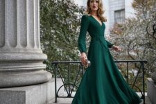 10 a bold green maxi dress with a deep V-neckline, long sleeves, a small embellished clutch bag for a fall wedding