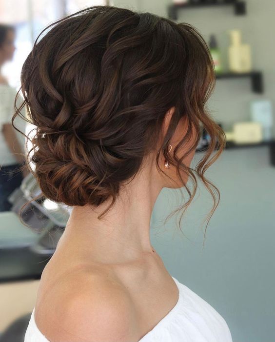a lovely low updo with a wavy top and a twisted touch, some waves framing the face is a romantic idea