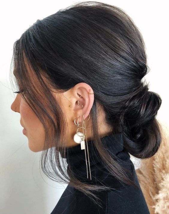 a low knot with a bump on top and some hair framing the face is a catchy and lovely idea for a bridesmaid