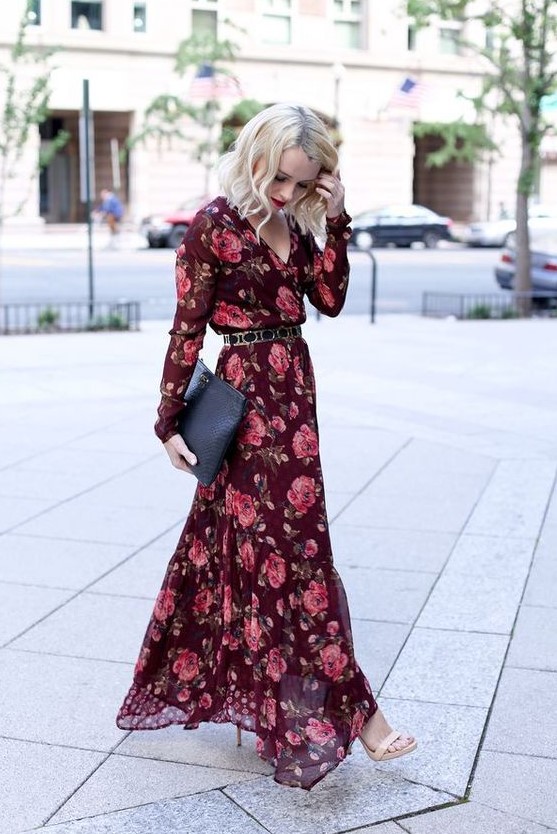 A burgundy floral maxi dress with long sleeves, V neckline, a belt, nude shoes and a clutch