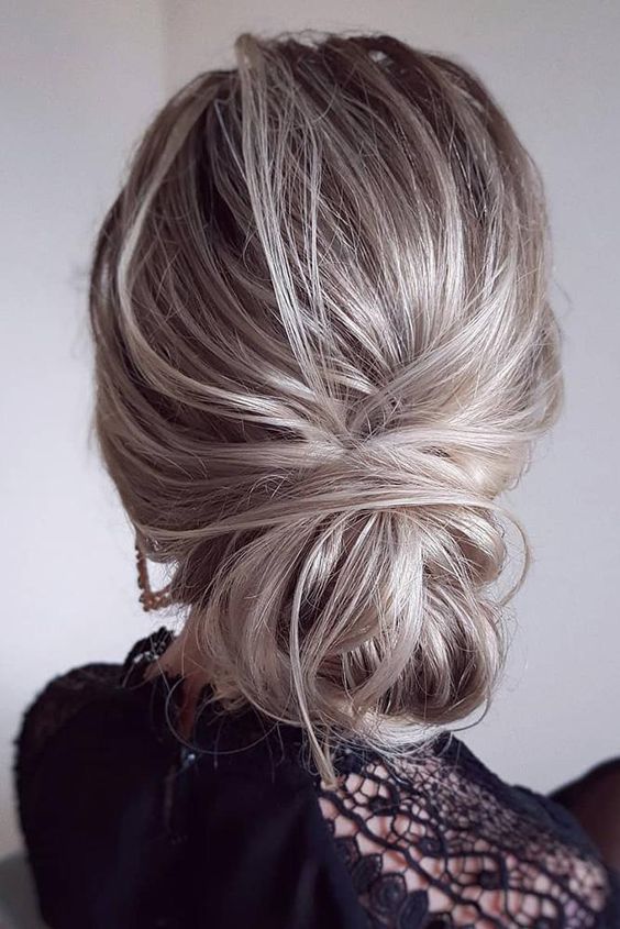 a messy low bun with a volume on top is a cool idea if you are looking for an updo but a more casual one