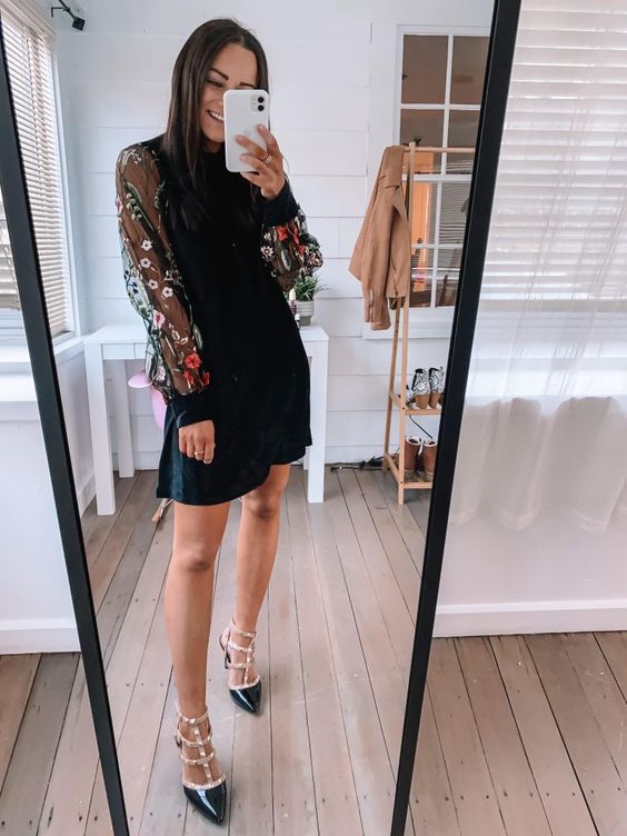 a catchy black mini dress with a high neckline, floral sleeves, black spiked shoes are a cool combo for a fall or winter wedding