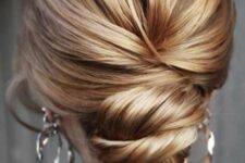 16 a modern twisted low bun with a volume on top is a stylish and catchy hairstyle for a modern bride