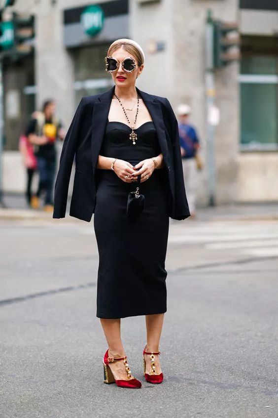 a chic wedding guest look with a black strapless dress, a blazer, red velvet embellished shoes, a small bag and statement sunglasses