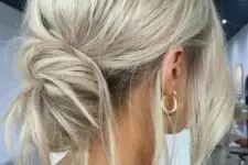 18 a messy low bun with a volume on top and some locks down is a perfect solution for a casual or boho wedding