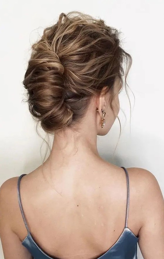 a chingon updo with a messy and wavy top plus some waves down is a cool idea for a modern and refined look