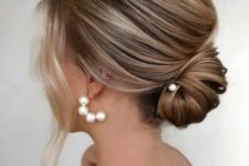 23 a dimensional low chignon with a volume on top and some face-framing locks is adorable