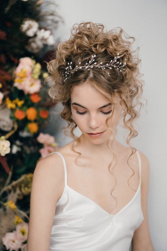 a dreamy curly updo with some curls down accented with a hair vine is a chic idea if you wanna look romantic