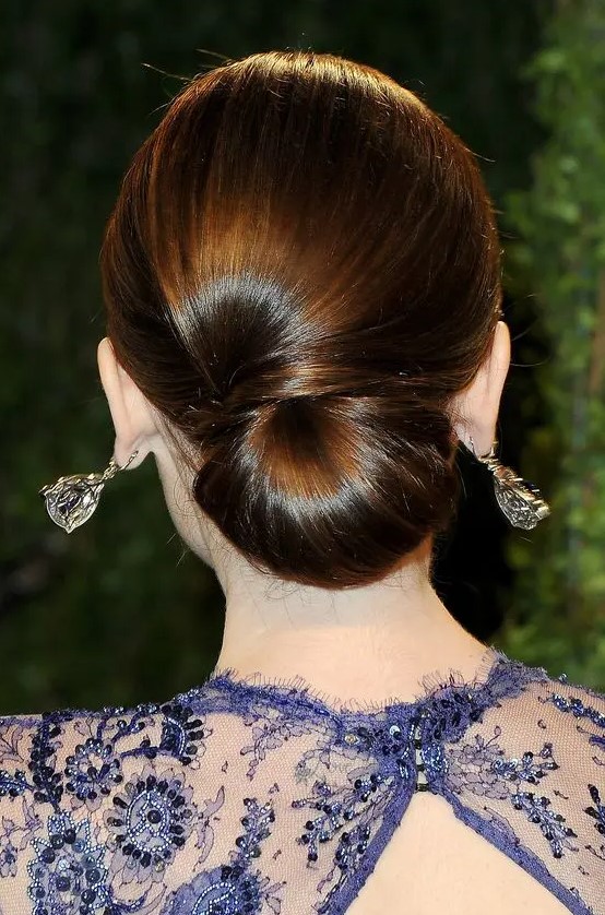 a elegant low chignon with a sideswept section is a very durable option for a picture-perfect look