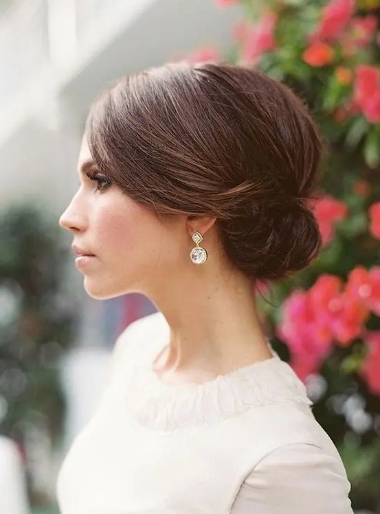 a sleek top and a small sided low bun for a timeless elegant look is suitable for medium and even short hair