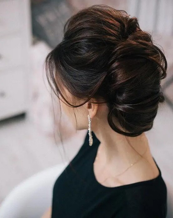 a large French twist chignon with a bump and messy touches for a breathtaking look