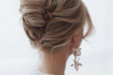 26 a lovely twisted chignon with a messy top and waves framing the face is a relaxed and effortless hairstyle