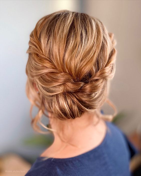 a twisted bridesmaid updo with a braided halo is a catchy and stylish idea for a boho wedding