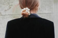 28 an elegant low bun with a sleek top and a pearl hair tie is a cool idea for a more formal wedding