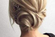 29 a low side swept twisted chignon with some bangs and a rhinestone hairpiece for an accent