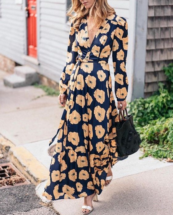 A navy floral maxi wrap dress with long sleeves, white shoes   just add a statement clutch and go