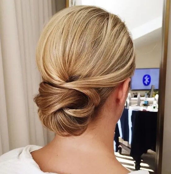A low twisted chignon looks interesting and non typical, perfect for an elegant look