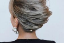 31 a messy and voluminous twisted chignon hairstyle with side bangs and a bit of hair pins is a stylish idea for a mother of the bride