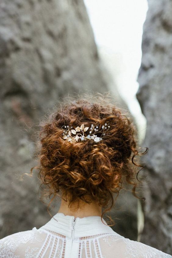 a messy curly updo with a curly top and curls down plus a rhinestone and pearl hairpiece is amazing