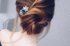 32 a messy twisted low chignon hairstyle with some bangs and a large hairpiece on one side for a relaxed look